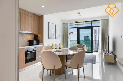 a kitchen and dining room with a table and chairs at Keysplease 2 BR Beach Vista, Emaar Beachfront in Dubai