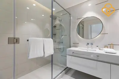 a white bathroom with a sink and a mirror at Keysplease 2 BR Beach Vista, Emaar Beachfront in Dubai