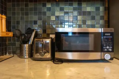 a microwave and a toaster oven on a kitchen counter at Vacay Lettings - Stylish 1 Bedroom Apartment with Marina View, Dubai Marina in Dubai