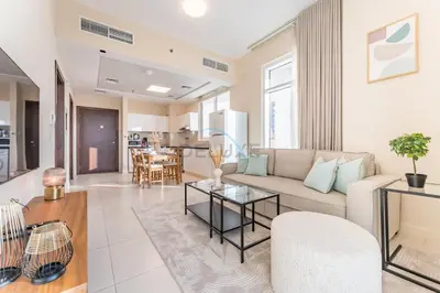 a living room with a couch and a table at Steps from Retail Stores and Sports Facilities 1BR, Binghatti Gateway, Al Jaddaf by Deluxe Holiday Homes in Dubai