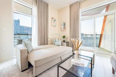 a living room with a couch and a large window at Steps from Retail Stores and Sports Facilities 1BR, Binghatti Gateway, Al Jaddaf by Deluxe Holiday Homes in Dubai