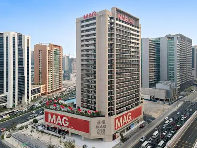 a large building with a macys sign on it in a city at Cozy Studio in Business Bay in Dubai
