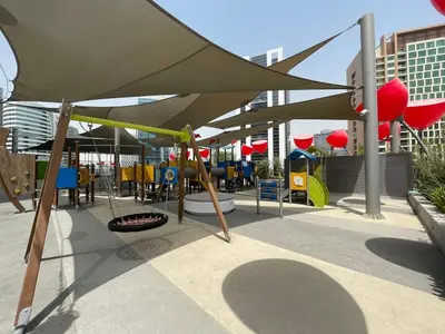 a patio with a playground with a large umbrella at GuestReady - Business Bay delight in Dubai