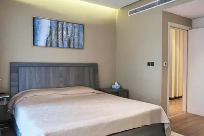 a bedroom with a bed and a picture on the wall at Elegant 2BR in Dubai Marina in Dubai