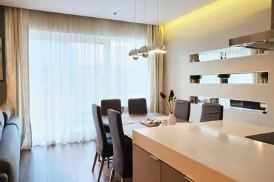 a kitchen and dining room with a table and chairs at Elegant 2BR in Dubai Marina in Dubai