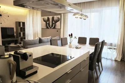 a kitchen and living room with a couch and a table at Elegant 2BR in Dubai Marina in Dubai