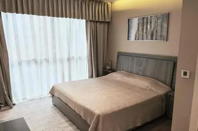 a bedroom with a bed and a large window at Elegant 2BR in Dubai Marina in Dubai
