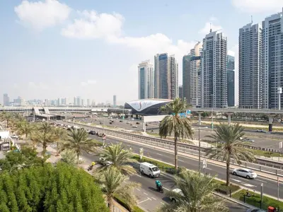 a city with tall buildings and a highway with cars at Amiqa Homes Dubai Marina in Dubai