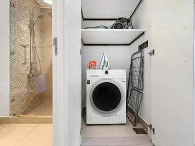 a laundry room with a washing machine in it at Collective Chic 1BR 15mins to Downtown Dubai Mall Beaches in Dubai