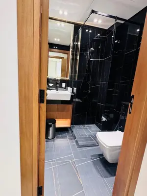 a bathroom with a toilet and a sink at Elegant 1BR Apt in JVC Dubai with Spacious Balcony & City Views in Dubai