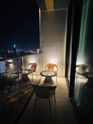 a balcony with a table and chairs on a building at Elegant 1BR Apt in JVC Dubai with Spacious Balcony & City Views in Dubai