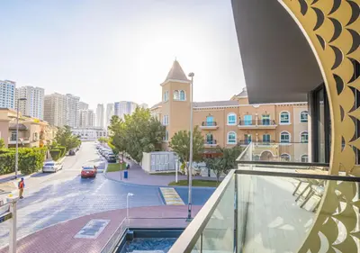 a view of a street from a balcony of a building at Spacious 3BR Apartment in JVC Dubai Modern & Cozy Stay in Dubai
