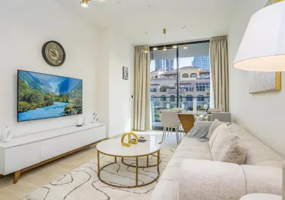 a living room with a couch and a table at Spacious 3BR Apartment in JVC Dubai Modern & Cozy Stay in Dubai