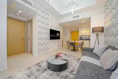 a living room with a couch and a table at Modern Sunset View 2Bhk 6pax in Dubai