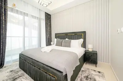 a bedroom with a large bed and a window at Modern Sunset View 2Bhk 6pax in Dubai