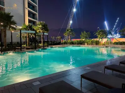 a large swimming pool at night with a building at Modern Sunset View 2Bhk 6pax in Dubai