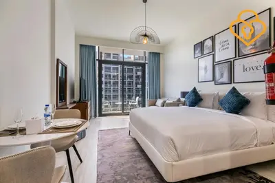 a bedroom with a large bed and a living room at Keysplease Studio Azizi Riviera Near Downtown, Meydan One in Dubai
