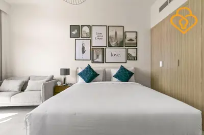 a white bedroom with a large bed and a couch at Keysplease Studio Azizi Riviera Near Downtown, Meydan One in Dubai