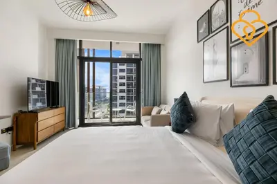a bedroom with a large bed and a tv at Keysplease Studio Azizi Riviera Near Downtown, Meydan One in Dubai