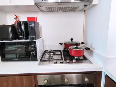 a stove with a microwave and a pot on it at Burj View 2BR Near Dubai Mall Fast Wi-Fi Balcony in Dubai