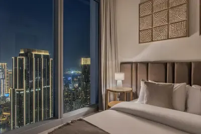 a bedroom with a large window with a city skyline at High Floor Apartment with full Burj Khalifa View, Opera & Fountain - Downtown Dubai - Forte Tower by Stayfinity in Dubai