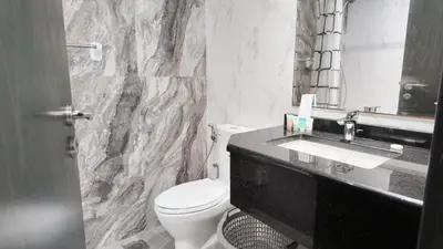 a bathroom with a white toilet and a sink at High Floor - Bright Elite Studio in Business Bay in Dubai
