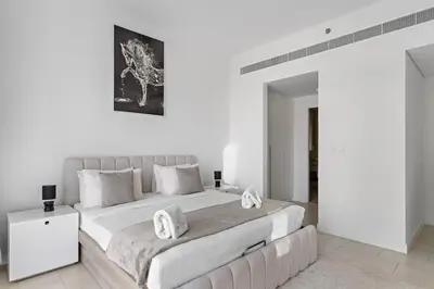 a white bedroom with a large bed and a couch at Spacious Dubai Marina 2BR Great Views Top Location in Dubai