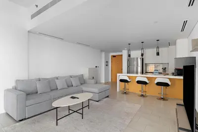 a living room with a couch and a table and a kitchen at Spacious Dubai Marina 2BR Great Views Top Location in Dubai