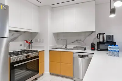 a kitchen with white cabinets and a stove top oven at Spacious Dubai Marina 2BR Great Views Top Location in Dubai