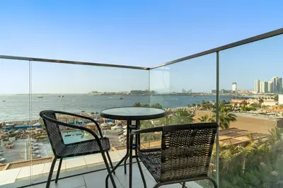 a balcony with a table and two chairs and the ocean at Spacious Dubai Marina 2BR Great Views Top Location in Dubai