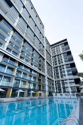a large apartment building with a swimming pool at Brand New Cozy 2br Apartment In Jvc With Balcony in Dubai