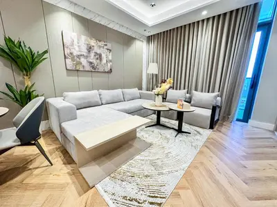 a living room with a couch and a table at Vserve 1 BR Stay with Stunning Skyline Views in Dubai