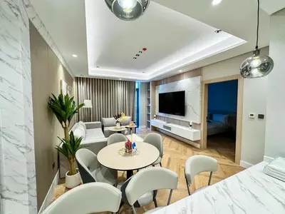 a living room with a table and chairs at Vserve 1 BR Stay with Stunning Skyline Views in Dubai