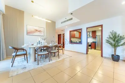 a dining room with a table and chairs at Close to Major Landmarks 3BR and Assistant Room with Marina Views, Rimal 5, JBR by Deluxe Holiday Homes in Dubai