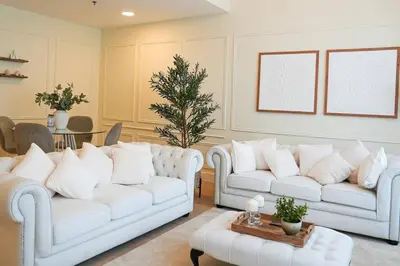 a living room with two white couches and a christmas tree at Luxe JLT 1BR Apt Gym Pool & Stunning Views in Dubai