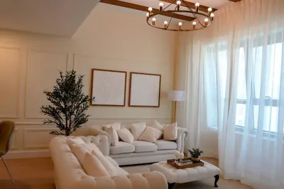 a living room with a white couch and a large window at Luxe JLT 1BR Apt Gym Pool & Stunning Views in Dubai