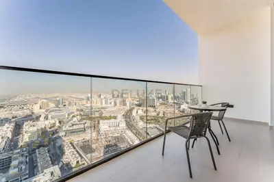 a dining room with a view of the city at City Views 1BR Near Community Park with Private Balcony, Binghatti House, Jumeirah Village Circle by Deluxe Holiday Homes in Dubai