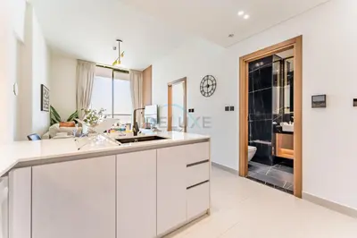 a kitchen with white cabinets and a counter top at City Views 1BR Near Community Park with Private Balcony, Binghatti House, Jumeirah Village Circle by Deluxe Holiday Homes in Dubai