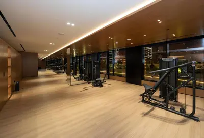 a gym with a row of exercise equipment in a building at Premium 2br Apartment With Private Pool In Jvc in Dubai