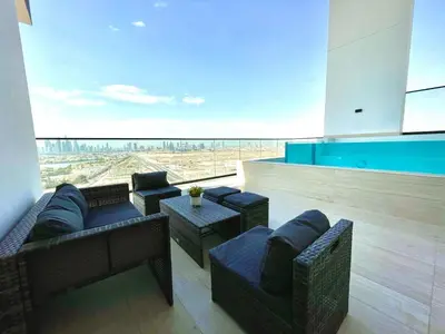 a living room with couches and tables and a view at Premium 2br Apartment With Private Pool In Jvc in Dubai