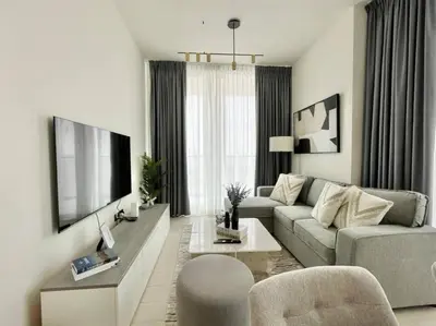 a living room with a couch and a tv at Premium 2br Apartment With Private Pool In Jvc in Dubai