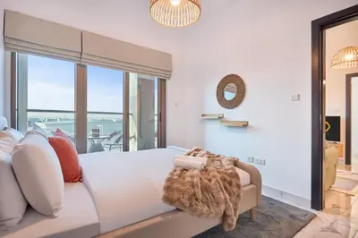 a bedroom with a large bed and a large window at Family-Friendly 2BR Apartment in Dubai South at MAG-565 near EXPO and Al Maktoum Airport DWC in Dubai