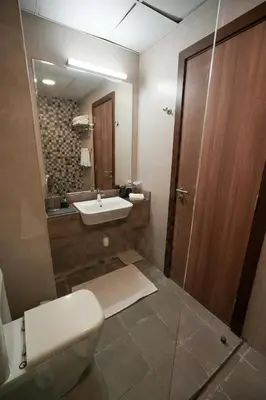 a bathroom with a toilet and a sink and a mirror at Your comfy stylish studio in Dubai 2guest and baby in Dubai