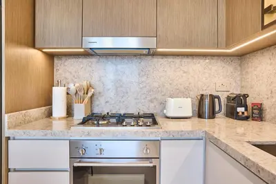 a kitchen with a stove and a counter top at Luxury 2BR Apartment in Grand Bleu Tower at EMAAR Beachfront - High Floor with Marina and City View, Private Beach Access by Stayfinity in Dubai