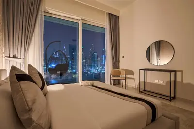 a bedroom with a large bed and a large window at Luxury 2BR Apartment in Grand Bleu Tower at EMAAR Beachfront - High Floor with Marina and City View, Private Beach Access by Stayfinity in Dubai