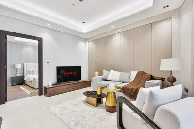 a living room with a couch and a fireplace at Stylish New Apt, Minutes from Downtown Dubai in Dubai