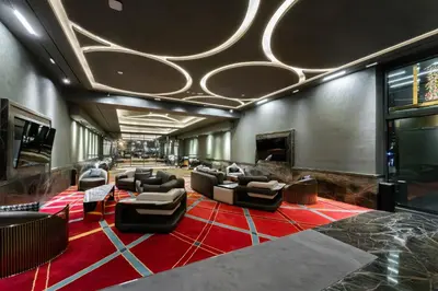 a lobby with couches and chairs on a red carpet at SettlerHomes - Elegant JLT Lakefront Near Metro in Dubai