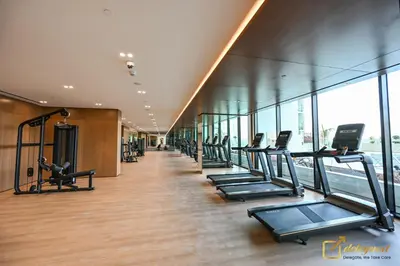 a row of treadmills in a gym with windows at Marvelous 1BR in Binghati Amber by deleguest in Dubai