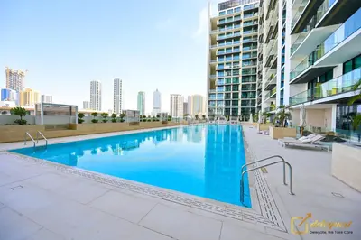 a large swimming pool on the roof of a building at Marvelous 1BR in Binghati Amber by deleguest in Dubai