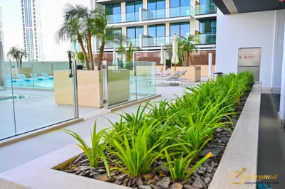 a courtyard in a building with palm trees at Marvelous 1BR in Binghati Amber by deleguest in Dubai